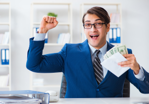 a man in a suit holding money in an envelope celebrating salary raise